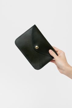 The Envelope Wallet is made of vegetable tanned leather and is secured with a steel snap. This Unisex item can be used as a simple wallet, passport holder, and even a clutch. Vegetable-tanned leather ages beautifully and is biodegradable. With proper care, this item can last for many years. It can be treated with a leather care oil to condition and clean; this process will slightly darken the leather. This artisanal product is made of genuine leather. All scars are characteristics of the skin an Simple Wallet, Thick And Fit, Envelope Wallet, Luxury Logo, Black Wallet, Aging Beautifully, Unisex Accessories, Wallet Fashion, Leather Care