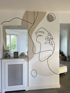 a room with a large mural on the wall