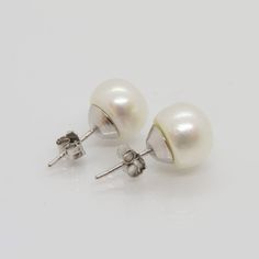 Vintage Sterling Silver White Pearl Stud Earrings ...Marked 925...Total of weights 3.5grams...Measure of Pearl 10MM...These are in very good condition. Classic Sterling Silver Plug Earrings For Formal Occasions, Classic White Gold Plug Earrings, White Gold Pierced Pearl Earrings, White Gold Round Pierced Pearl Earrings, Round White Gold Pierced Pearl Earrings, Classic Sterling Silver Round Plug Earrings, Classic Round Sterling Silver Plug Earrings, Classic Pierced Plug Earrings For Anniversary, Classic Hallmarked Sterling Silver Pearl Earrings