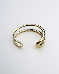 The Formation Wrist Cuff is an essential styling piece. Based on the shape of our Organic Long Hoops and wrapped into a modern wrist cuff form, this is a timeless piece that will elevate any outfit. Wear it with other styles from our core collection. DETAILS: High micron, ethically sourced 18K gold certified by LBMA Responsible Gold to meet international ethics standards. Eco brass base metal with 18K gold plating or solid 925 sterling silver. 6 months warranty Nickel free. Packaged in F+H brand Timeless Adjustable Gold Cuff Bracelet, Adjustable Open Cuff Bracelet For Formal Occasions, Timeless Adjustable Cuff Bracelet With Strap, Elegant Double Band Gold Cuff Bracelet, Elegant Gold Double Band Cuff Bracelet, Adjustable Cuff Bracelet With Polished Finish, Adjustable Timeless Bangle Cuff Bracelet, Gold Open Band Cuff Bracelet Minimalist Style, Gold Minimalist Open Band Cuff Bracelet