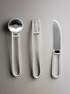 there are three forks and two spoons next to each other