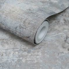 a roll of grey wallpaper on the ground