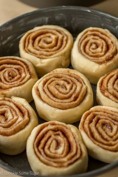 several cinnamon rolls in a pan on a table