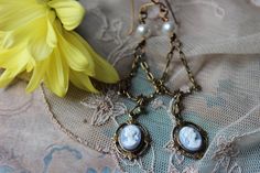 "Enchanting Blue Cameo in a lovely design called the Kathrine Necklace. Features a drop portrait cameo in a leaves embellished setting hanging from an ornate drop. Pearls and cast floral antiqued golden beads are hand linked and wire-wrapped to enhance the lovely tones and textures of this Victorian cameo. Your necklace will be finished with antiqued gold chain that is finely textured. Closure is done with our hand forged loops which are durable and allow adjustable length. You necklace has a lo Vampire Diaries Necklace, Christmas Gift Earrings, Necklace With Pearls, Victorian Earrings, Victorian Necklace, Cameo Earrings, Special Necklace, Summer Gifts, Spring Gifts