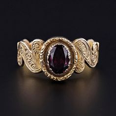 This Victorian era, antique ring (circa 1860-1870) features a rhodolite garnet set in hand engraved 9ct gold. The inside of the band bears the initials 'JY'.  The ring is a size 9.5, but it can be re-sized free of charge.  It is in excellent condition; however, the garnet is a later replacement and not original to the ring.  We have many other fantastic offerings of antique and vintage jewelry posted on our Etsy store, so please consider browsing our other items. We send all items in individually packaged gift boxes and offer layaway plans! + Trademark Antiques Shop Homepage https://www.etsy.com/shop/TrademarkAntiques + Our Store Policies https://www.etsy.com/shop/TrademarkAntiques/policy?ref=shopinfo_policies_leftnav + Connect with us on Social Media (Get access to monthly giveaways, spec Victorian Yellow Gold Ruby Ring With Intricate Design, Victorian Ruby Ring In Yellow Gold With Intricate Design, Victorian Engraved Yellow Gold Ring, Antique Ruby Signet Ring, Antique Hallmarked Ruby Signet Ring, Victorian 14k Gold Engraved Ring, Victorian Oval Ruby Ring, Victorian 14k Gold Ruby Ring With Intricate Design, Victorian Yellow Gold Ruby Promise Ring