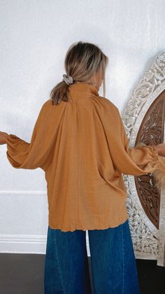 Seasonal bliss, this dolman style blouse is featured in an oversized, slouchy fit with classic button-front neckline and a rich camel color tone creating the ideal fall blouse. Neckline: Button up with collar Fabric: 80% Rayon, 20% Nylon Details: Oversized fit, cuffed long dolman sleeve, button up bodice Imported Fit: Oversized! - Arms: Relaxed - oversized dolman style Model Specs: Karli is wearing a size s/m in the photo. How will this item fit you? Check out our MODEL SPECS (Typical Sizing - Karli: S-Size 5/26 - 5ft 2in, Emily: S-Size 3/25 - 5ft 5in, Syd: L/XL- Size 15/ - 5ft 8in)Need help with sizing? No problem! Join our VIP group on Facebook, Everyday Chic Boutique VIP Insiders to chat directly with our team and other customers just like you.Packaged with love and shipped from our war Blouse Neckline, Fall Blouse, Vip Group, Everyday Chic, Vintage Fall, Style Blouse, Holiday Looks, Color Tone, Camel Color