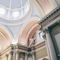 the inside of a building with columns and arches