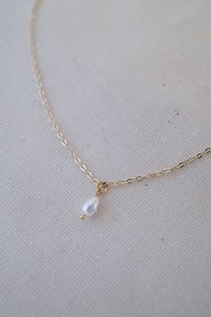 14k gold-filled dainty freshwater pearl necklace - Etsy #pearlnecklace #daintyjewelry #daintynecklace #daintypearlnecklace #necklace #necklaceoftheday #necklaceshop #necklaceoutfit #goldjewellery #goldjewelry #dainty #elegantnecklace #pearl #pearljewellery #pearljewelry #jewelryaddict #jewelrylover #jewelryforwomen #etsyshop #etsyjewelry #handmadejewelry #handmadenecklace #freshwaterpearlnecklace #aestheticnecklace #simplenecklace #goldfillednecklace #necklaceforwomen #necklaceforgirls #giftforh Wedding Charm Necklace With Delicate 14k Gold Filled Chain, 14k Gold-filled Teardrop Pearl Chain Jewelry, Dainty Gold Briolette Necklace, Pearl Dangle Chain Necklace As A Gift, Pearl Dangle Chain Necklace Gift, Pearl Dangle Chain Necklace For Gifts, Gold Drop Necklaces With Pearl Charm, Delicate Drop Chain Necklace Gift, Gold Drop Dainty Jewelry