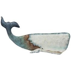 a ceramic whale sculpture sitting on top of a white surface