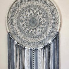 a decorative wall hanging made out of blue and white material