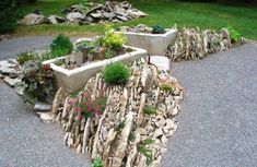 there are several planters made out of rocks