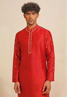 Presenting a regal Red Silk Kurta Set, featuring a Chinese collar and looped fabric buttons for a classic look. The hand-embroidered details on the neckline, shoulder, and sleeves add a touch of elegance. Paired with white pants, this ensemble is perfect for Mehendi or Sangeet events, offering a blend of traditional charm and sophisticated style. Composition : Chanderi Silk Care: Dry Clean Only and Vacuum Storage This product can be customized for sleeves, length and colour Delivery : 4-6 weeks as the product is hand crafted. Check Size Guide or choose MySize for free customisation (All Sizes above XL can be made at 15% additional cost) For more information and sizes please contact fabiliciousfashion@gmail.com or visit our Copenhagen studio. About the Designer : Shreyansh, a distinguished Festive Kurta With Set-in Sleeves, Fitted Sets With Embroidered Sleeves For Festive Season, Festive Straight Kurta With Set-in Sleeves, Traditional Sets With Set-in Sleeves For Eid, Elegant Traditional Wear With Embroidered Sleeves For Wedding, Elegant Wedding Traditional Wear With Embroidered Sleeves, Traditional Designer Kurta With Set-in Sleeves, Fitted Kurta With Embroidered Sleeves For Festivals, Red Embroidered Sets For Traditional Ceremonies