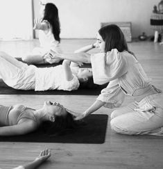 three women doing yoga on mats in a room