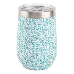 a blue and white tumbler cup with leaves on the side, sitting against a white background