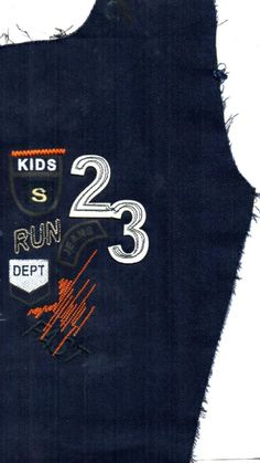 a piece of torn up clothing with numbers on the front and two kids's runs written on it