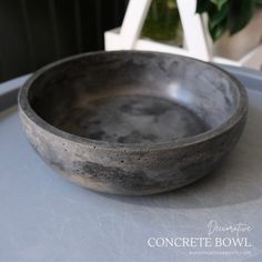 a gray bowl sitting on top of a table