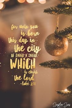 a christmas ornament hanging from a tree with the words for unto you is born this day in the city of david a savor which he