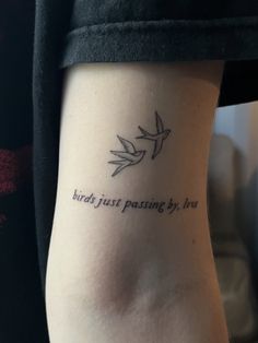 a woman with a bird tattoo on her arm that says birds just passing by love