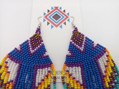 "Beautifully handmade Native American Style Seed Bead Earrings with woven in a combination of desert and mountain colors. Traditional native style design at nearly 6\" off the ear. Colors and styling great for matching your favorite dancing regalia or to wear on its own. Made with stainless steel ear wires and genuine high quality beads. All handmade and Shipped Free from Hawaii with Aloha!" Fair Trade Multicolor Beaded Earrings For Festival, Multicolor Fair Trade Beaded Earrings For Festival, Artisan Purple Beaded Earrings, Handmade Southwestern Multicolor Beaded Earrings, Handmade Multicolor Southwestern Beaded Earrings, Handmade Southwestern Multicolor Earrings, Southwestern Multicolor Beaded Earrings For Beach, Adjustable Multicolor Handwoven Beaded Earrings, Traditional Purple Beaded Earrings For Festivals