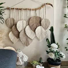 a living room filled with furniture and lots of plants on top of a wooden table