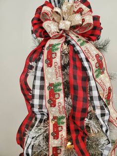 a christmas tree decorated with red and black plaid ribbon