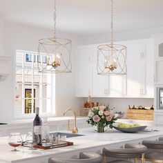 a kitchen with white counter tops and gold pendant lights hanging from the ceiling over the island