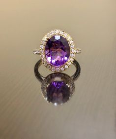 DeKara Designs Collection Metal- 18K Yellow Gold, .750. Stones- 1 Oval Genuine Amethyst 11.5 MM x 9.00 MM, 44 Round Diamonds F-G Color VS1-VS2 Clarity, 0.46 Carats. Latest of my creations! A Beautiful Amethyst Diamond Halo Engagement Ring Made in 18K Yellow Gold. There is a beautiful genuine purple Amethyst in the center of the ring that is professionally set in between four double prongs. The Amethyst is a beautiful and rich in color and goes extremely well with the yellow gold. Amethyst is sur Luxury Purple Gemstones With Halo Setting, Elegant Yellow Gold Amethyst Ring With Brilliant Cut, Luxury Yellow Gold Amethyst Ring With Gemstone Accents, Luxury Gemstones With Halo Setting For Wedding, Luxury Halo Setting Gemstones For Wedding, 14k Yellow Gold Amethyst Ring With Halo Setting, Luxury White Gold Amethyst Ring With Gemstone Accents, Luxury Yellow Gold Amethyst Ring With Prong Setting, Exquisite Yellow Gold Amethyst Ring With Accent Stones