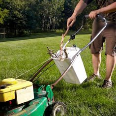 a man mowing the grass with a lawnmower