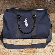 20” Wide, 11” Height, 10” Deep. Adjustable Straps. Navy Blue Color. Faux Leather Sturdy Bottom. Blue Duffle Bag With Zipper Closure, Everyday Blue Duffle Bag With Zipper Closure, Blue Sporty Travel Bag For On-the-go, Blue Rectangular Gym Bag With Zipper Closure, Blue Sporty Bags For Travel, Navy Shoulder Bag With Dust Bag For Travel, Blue Gym Bag With Zipper Closure, Blue Gym Bag With Zipper Closure For Daily Use, Blue Gym Bag With Zipper For Daily Use