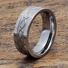 a wedding ring with an engraved design on it