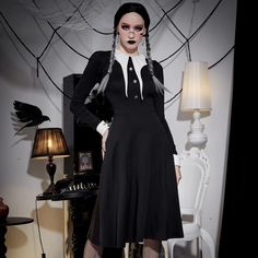 Transform into a bewitching beauty with our Gothic Costume Long Sleeve Dress. Perfect for Halloween and cosplay, this knee-length dress features elegant long sleeves and a striking black color palette, accentuated by a bold white collar. Embrace your dark and sophisticated side with this Addams Family-inspired ensemble, making it the perfect choice for a timeless, eerie look. Knee-length dress for classic appeal Elegant long sleeves Striking white collar for contrast Black color palette for a Gothic vibe Perfect for Halloween and cosplay Halloween Vampire Style Long Sleeve Dress, Witchy Long Sleeve Cosplay Dress, Witchy Long Sleeve Costume Dress, Vampire Style Long Sleeve Cosplay Dress, Witchy Long Sleeve Dress For Costume Party, Gothic Long Sleeve Dresses For Cosplay Events, Long Sleeve Gothic Dresses For Cosplay Events, Black Long Sleeve Gothic Midi Dress, Elegant Long Sleeve Halloween Dress