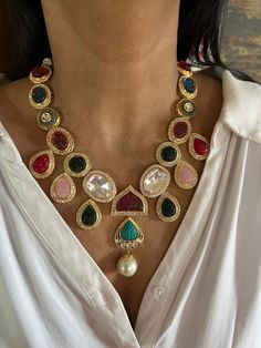 All our pieces are in stock and will be dispatched within 24 to 48 hours of order. Orders received during the weekend will be dispatched on Monday One of our favorite picks for the wedding season ❤️ Comes with an adjustable string. Material: Brass and copper mix, gold polish, CZ stones, Polki Kundan, carved Quartz stones, pearls Dimensions Weight of Necklace is 90 g. Drop Length of Necklace: 11 inches Necklace comes with adjustable Dori. Weight of Earrings is 22 g per pair. Length of Earrings: 5 cms, push back closure. Width of Earrings: 3.5 cms. Gold Kundan Necklace With Stones In Temple Jewelry Style, Multicolor Gold Plated Fusion Jewelry, Gold Multi-stone Fusion Jewelry, Gold Fusion Multi-stone Jewelry, Fusion Style Jeweled Jewelry Sets For Festive Occasions, Multicolor Fusion Style Gold Plated Jewelry, Multicolor Fusion Gold Plated Jewelry, Elegant Festive Multi-stone Jewelry Sets, Multicolor Fusion Gold-plated Jewelry