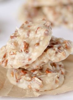 three cookies are stacked on top of each other with white frosting and walnuts