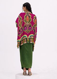 This vibrant Rani Pink and Green Embroidered Toga Kurta Dhoti Set showcases a rich blend of colors and patterns for an elegant, modern ethnic look. The striking rani pink kurta is crafted from soft crepe fabric and features a beautifully detailed paisley design, while its asymmetrical hemline brings a contemporary twist. Paired with flowy green dhoti pants, this indo western style ensures both comfort and ease of movement, making it ideal for festive celebrations or casual family gatherings. Composition : Top and Pants - Crepe Care: Dry Clean Only and Vacuum Storage This product can be customized for sleeves, blouse length and neckline Delivery : 4-6 weeks as the product is hand crafted. Check Size Guide or choose MySize for free customisation (All Sizes above XL can be made at 15% additio Traditional Drape Kaftan With Patterns, Fitted Multicolor Kaftan With Traditional Patterns, Multicolor Traditional Kaftan For Diwali, Bohemian Pink Sets With Traditional Patterns, Pink Fitted Bohemian Kaftan, Fitted Pink Bohemian Kaftan, Pink Bohemian Traditional Wear With Printed Motifs, Bohemian Pink Traditional Wear With Printed Motifs, Bohemian Pink Saree For Summer