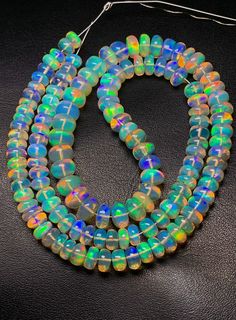 18 Inch Rare Natural Welo Ethiopian Opal Beads, Smooth Roundel Beads Strands, 6 To 8 MM Approx 104 Ct, Opal Plain Beads, Making Necklace.  Product Detail :-- Gemstone  :-   Natural Ethiopian Opal Shape  :-   Roundel   Size  :-   6 To 8 MM Approx Weight  :-    104 Ct   Quantity  :-  1 We have lots of designer fashion jewelry. We are manufacturer, wholesaler and exporter of gemstones and handmade jewelry. We always try fulfilled our customers requirements as per their sanctification. Because We wants to long term Business with you. For More Products, Click on below Link https://www.etsy.com/in-en/shop/firegemsandjewellery?ref=seller-platform-mcnav Thank You for Visit Our Shop Fire Gemstone Jewelry If you require additional quantities of this (or any other item), please ask! All of our prices Iridescent Polished Round Beads Jewelry, Iridescent Jewelry With Polished Round Beads, Artisan Rondelle Beaded Beads, Rainbow Spacer Beads, Iridescent Colorful Beaded Necklace, Multicolor 8mm Beads, Gems And Cabochons, 8mm Rondelle Beads For Jewelry Making, Rainbow Spacer Beads For Jewelry Making, Handmade Iridescent Beaded Necklaces With Round Beads