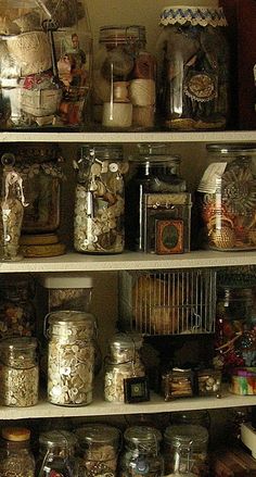 the shelves are filled with many different types of jars and other things in them,