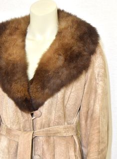 A beautiful vintage Rajac Leather women's coat sewn from a mottled tan suede in stripes or thin gores with a luxurious fox fur collar. ~ plunging V neckline which converts to a close-to-the-neck collar ~ satin ties and suede loop inner side closure ~ belt with belt loops ~ suede loops & suede-covered button closure  ~ insulated satin lining ~ front welt pockets  ~ multi-gored design ~ raglan sleeves [label]  Rajac Leathers [manufacturing]  made in Canada [fiber content]   suede, fox fur,  lining Suede Coat, Vintage Coat, Tan Suede, Fur Collar, Fur Collars, Vintage Wool, Fox Fur, Women's Coat, Neck Collar