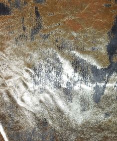 an image of a brown and black area with some white stuff on it's surface