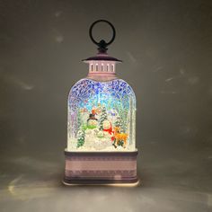 a decorative glass jar with a snowman inside