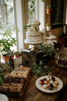 a table topped with lots of desserts and cakes