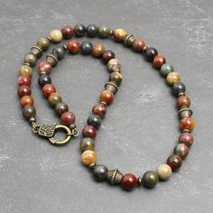 "* Made with Red Creek Jasper 8mm round beads, which has the earthy multi-colors of tan, olive green, burnt red, charcoal gray, and more. The softly muted colors of this natural stone makes it great for both men and women. * Embellished with antiqued brass finish pewter beads and brass spacers. It closes with an unique looking lobster clasp in antiqued brass finish pewter. * Strung with a professional quality durable wire, which is made of 49-strand fine stainless steel bundled and nylon coated. Bead Necklace For Men, Red Creek Jasper, Earthy Jewelry, Dope Jewelry, Natural Stone Jewelry, Funky Jewelry, Jewelry Lookbook, Bohemian Necklace, Copper Necklace