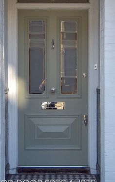 the front door to a house with two glass panels on it's side window