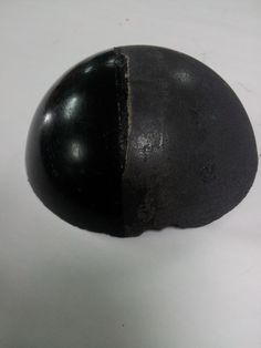 a black rock sitting on top of a white table