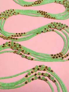 Single Strand Waist Bead, featuring delicate seafoam green glass seed beads accented with luxurious gold crystal glass beads. Why You'll Love It: Subtle Elegance: Seafoam green glass seed beads offer a soft, soothing sparkle that complements any outfit. Luxurious Accents: Gold crystal glass beads add a touch of sophistication and opulence. Perfect Fit: The adjustable single strand design ensures comfort and a secure fit for all body types. Cultural Beauty: This piece blends the rich heritage of Ivorian craftsmanship with modern elegance. Color Significance: Seafoam Green: In Ivorian culture, green symbolizes growth, harmony, and renewal. The seafoam green beads bring a sense of tranquility and balance. Gold: Gold represents wealth, prosperity, and high status. The gold accents provide a lu Handmade Green Waist Beads, Embellished Gold Jewelry For Festival, Gold Beaded Bracelets For Summer Parties, Green Beaded Glass Jewelry, Green Glass Beaded Jewelry, Gold Embellished Beaded Necklaces For Party, Festive Green Beaded Bracelets With Colorful Beads, Festive Green Beaded Bracelets, Green Beaded Chain Bracelets For Beach