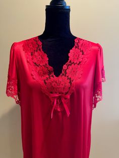 A beautiful lace trimmed nightgown in red. Perfect for Valentine's Day. Laced trimmed v-neck and sleeves. Decorative satin bow at the bust line. Side slits and a delicate lace trimmed hem. In good vintage condition with no rips or stains. The bust measures 19 inches from armpit to armpit laying flat. 34 inches from shoulder to hem. 100% Polyester. Made in the USA. Coquette Lace V-neck Nightgown, Red V-neck Summer Nightgown, Lace V-neck Nightgown With Lace Trim, Red V-neck Nightgown For Summer, Elegant Red V-neck Sleepwear, Feminine Lace V-neck Nightgown, V-neck Lace Trim Sleepwear For Wedding Night, V-neck Wedding Night Sleepwear With Lace Trim, Coquette Lace Trim V-neck Nightgown