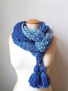 a crocheted scarf with tassels on top of a mannequin