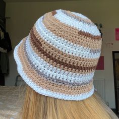 a woman with blonde hair wearing a crocheted hat on top of her head