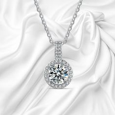 Introducing our stunning 1-carat high-quality sterling silver Moissanite necklace--the perfect combination of elegance, sparkle, and timeless beauty. This breathtaking necklace is crafted from premium sterling silver and features a dazzling Moissanite stone that radiates brilliance with every movement. Known for its fire and clarity, Moissanite offers the luxurious look of a diamond, making it a sophisticated yet affordable choice. Whether you're looking to elevate your everyday style or searching for the perfect gift for a special someone, this necklace will steal the show. Its versatile design makes it ideal for any occasion--birthdays, anniversaries, weddings, or simply treating yourself to something truly exquisite. Each necklace comes in a beautiful gift box, ready to impress from the Elegant Silver Solitaire Necklace, Elegant Silver Solitaire Necklace With Lab Grown Diamond, Elegant Silver Solitaire Necklace With Lab-grown Diamond, Elegant Silver Moissanite Diamond Necklace, Dazzling Silver Solitaire Necklace With Lab Grown Diamond, Elegant Silver Necklace With Lab Grown Diamond, Silver Necklace With Round Cut Lab Grown Diamond, Anniversary Halo Solitaire Cubic Zirconia Necklace, Anniversary Halo Solitaire Necklace In Cubic Zirconia