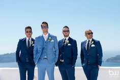 a group of men in suits and sunglasses standing next to each other on a roof