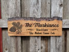 a wooden sign hanging on the side of a fence that says, the makainos